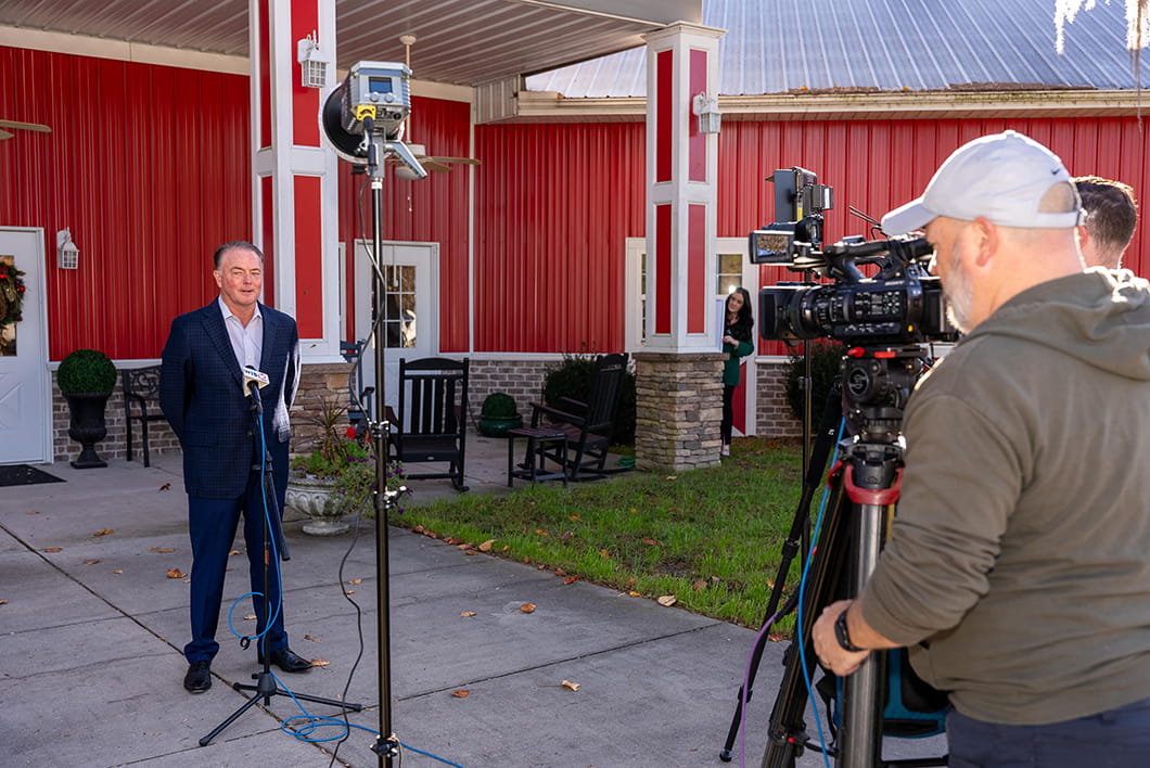 Tim Arnold speaking on camera to WISTV 10 at the Big Red Barn Retreat